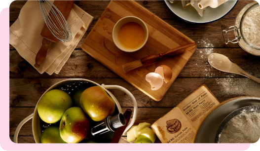 Baking ingredients and apples on a wooden table