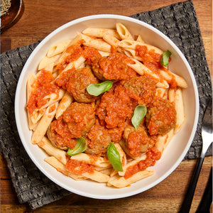 Penne with meatballs in tomato sauce and basil